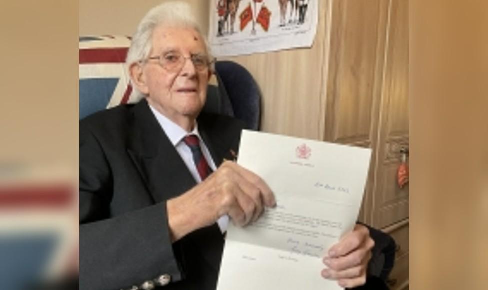 Roger Jones holding a letter from the Queen