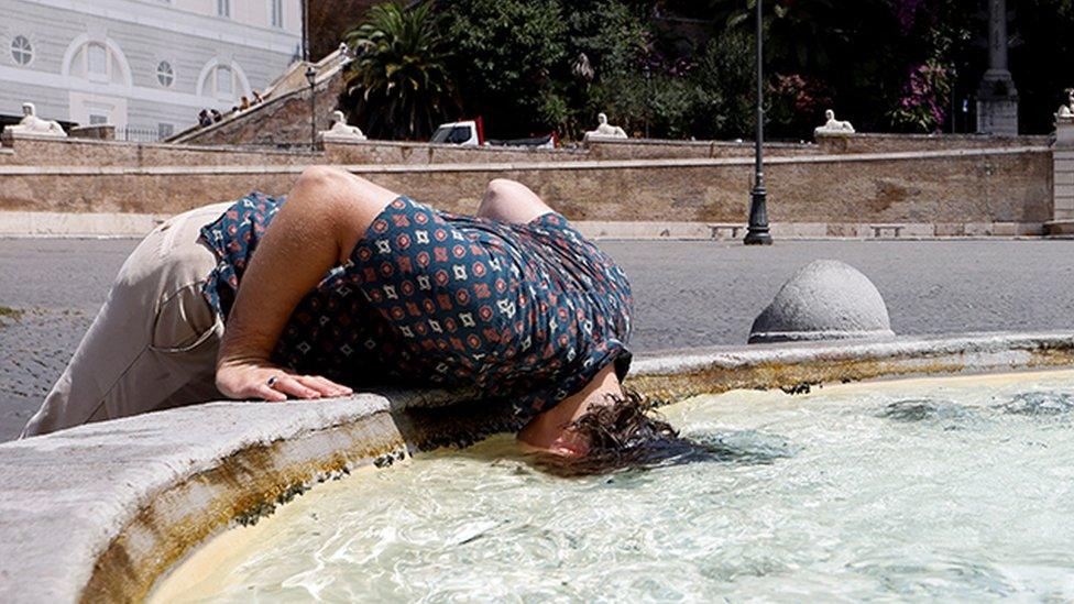 A person cools off at the Piazza del Popolo in Rome, Italy, on 18 July 2023