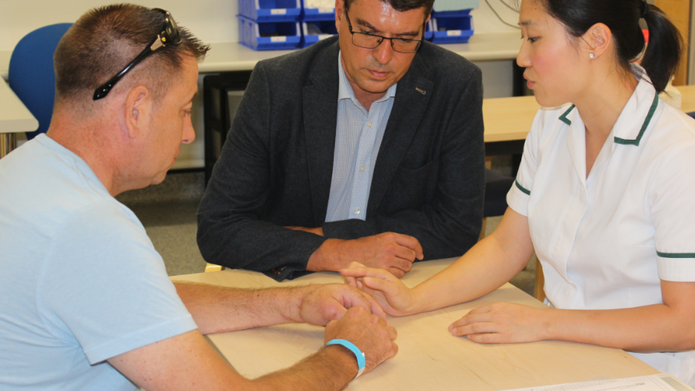 Anthony (L) with Mr Adlard and physio Millie Chu