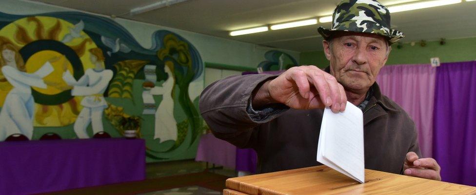 A man casts his ballot during pre-term presidential elections at a polling station in the Belarus village of Dukora.