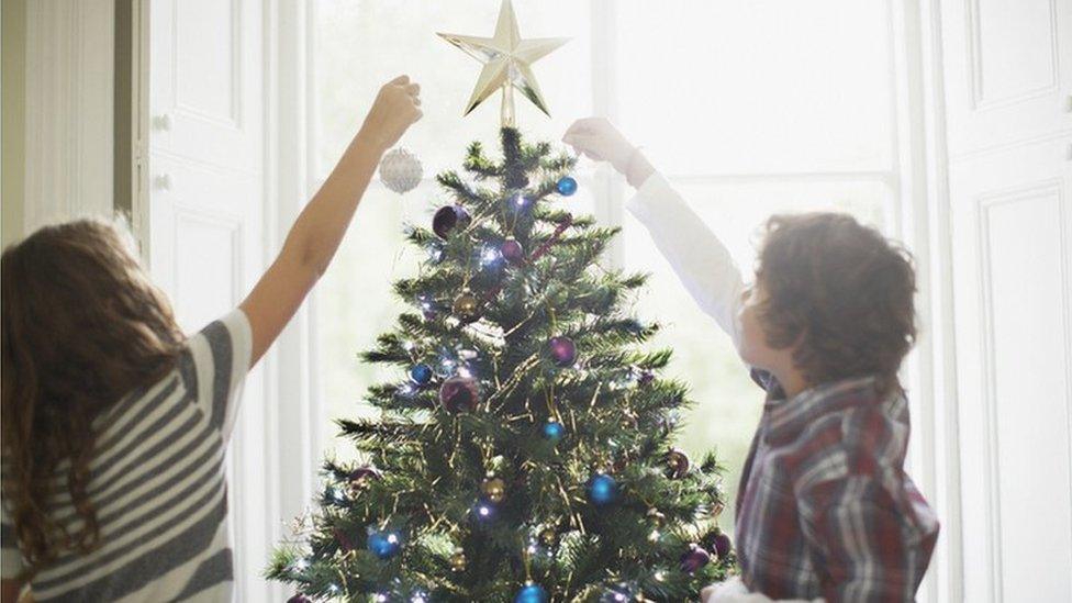 Children decorating Christmas tree