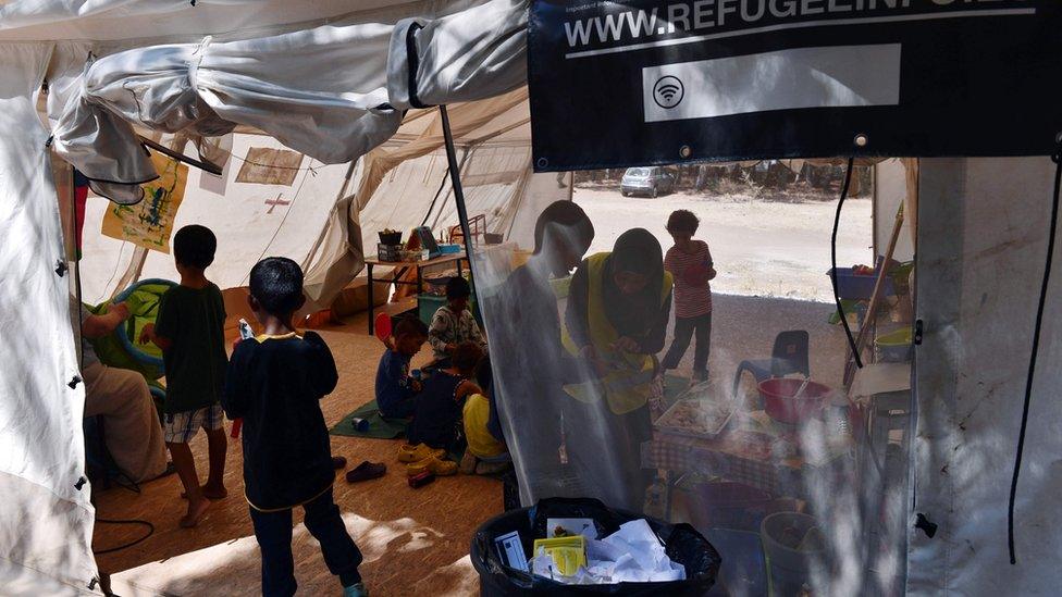 A picture taken on August 31, 2016 shows children play in a tent at the " Village All together" or PIKPA village on the island of Lesbos.