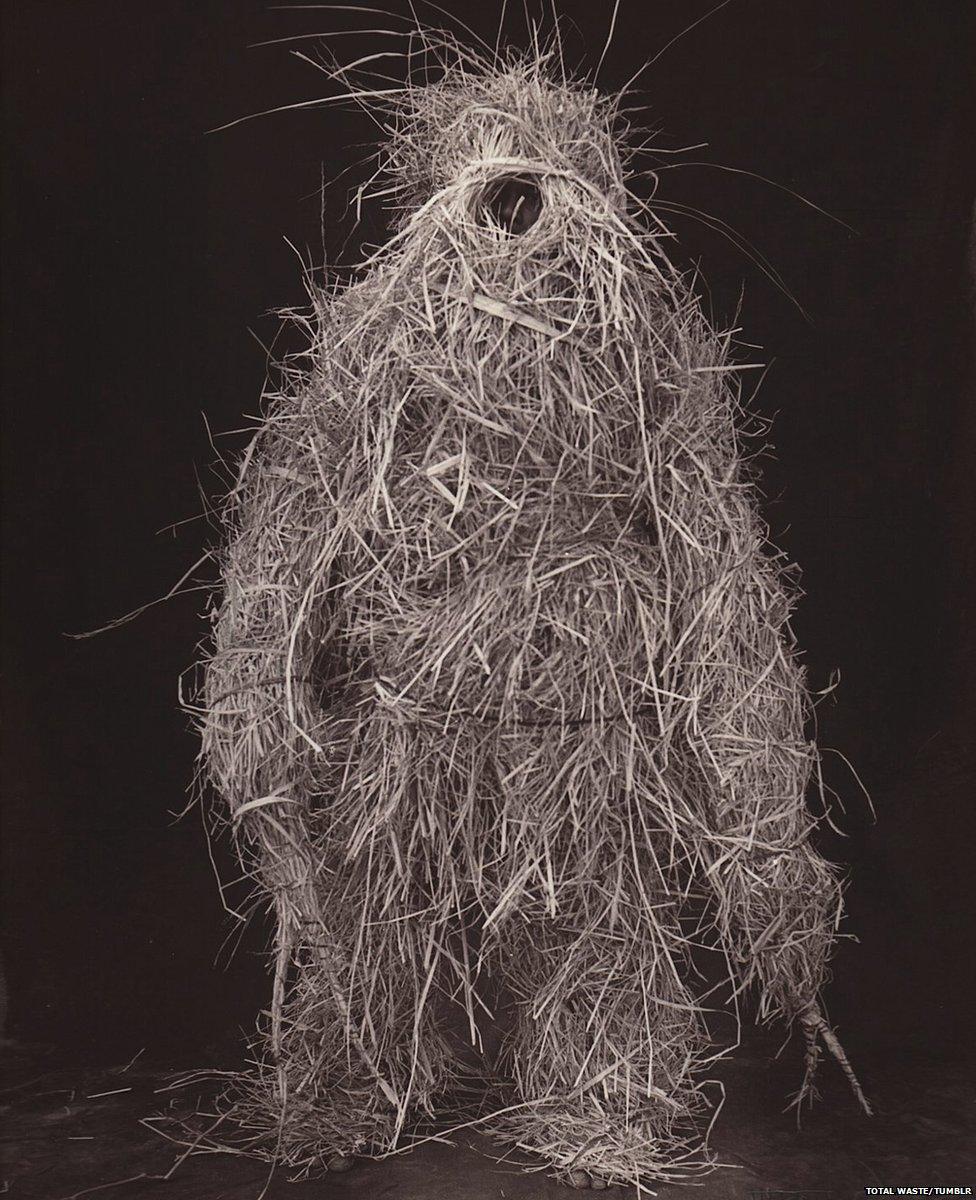 A person covered in straw