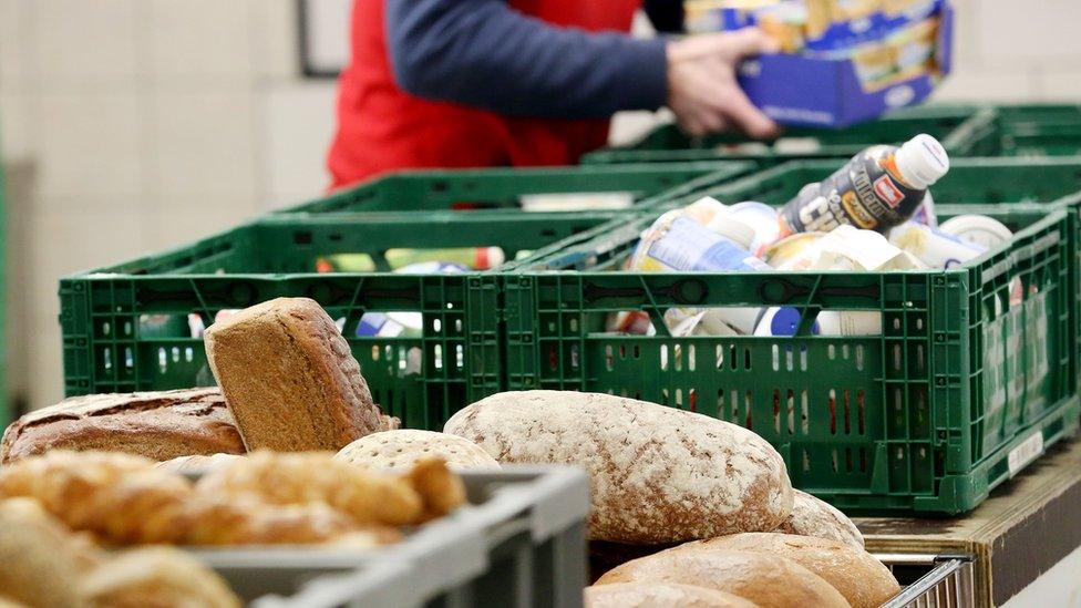 A helper sorts food at the distribution site of the "Essener Tafel" food bank distributing food to people in need in Essen, western Germany, on February 23, 2018