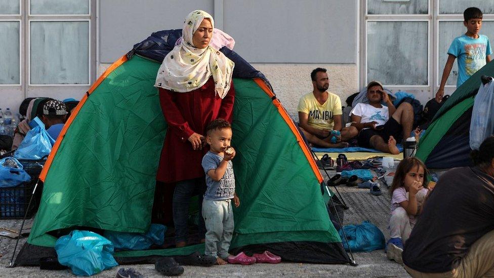 Migrants near burnt-out Moria camp, 16 Sep 20