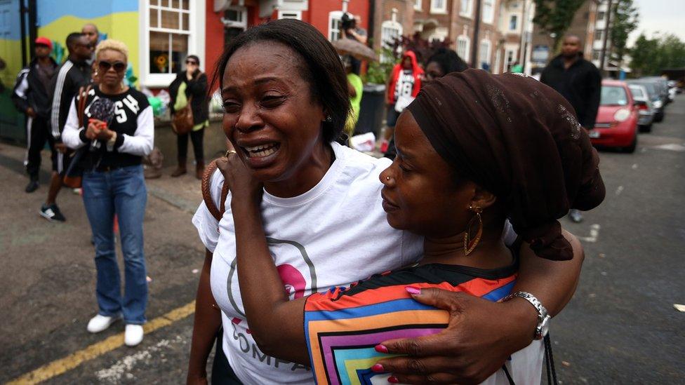 A woman is comforted as she breaks down in tears outside a Kids Company premises on August 5, 2015 in Camberwell, London