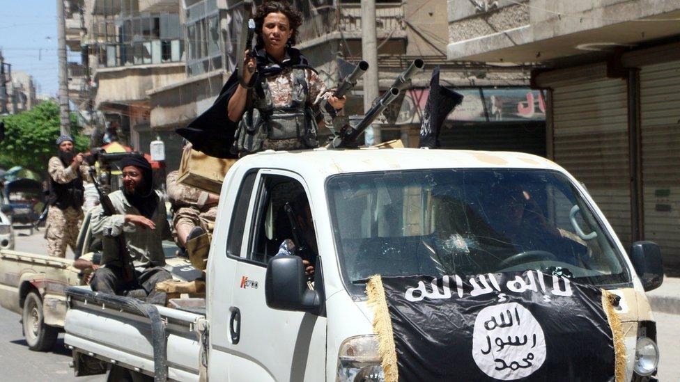 Fighters from the Al-Nusra Front drive in armed vehicles in the northern Syrian city of Aleppo