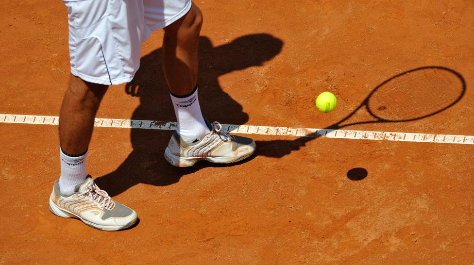 Serving on a clay court