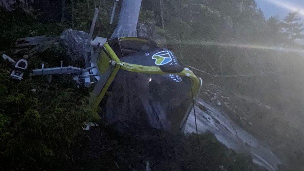 A cable car crumpled on the ground after the gondola ride was saboaged