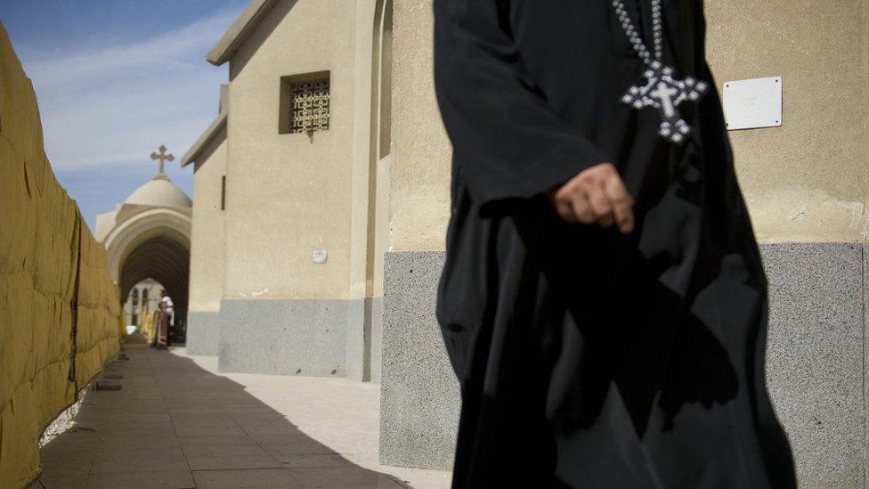 A Coptic Christian priest enters Saint Mark's Cathedral on November 4, 2012 in Cairo,