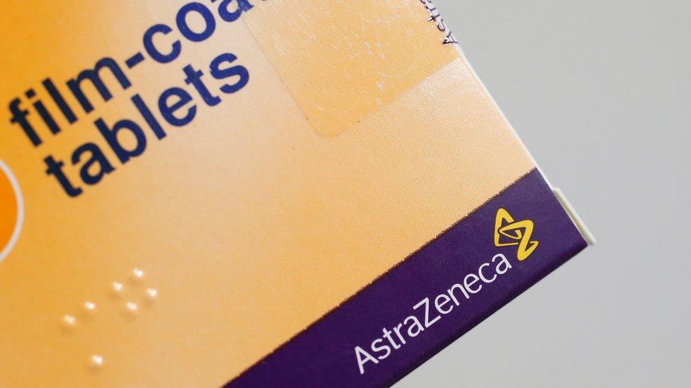 A yellow and navy pill packet bearing the AstraZeneca logo