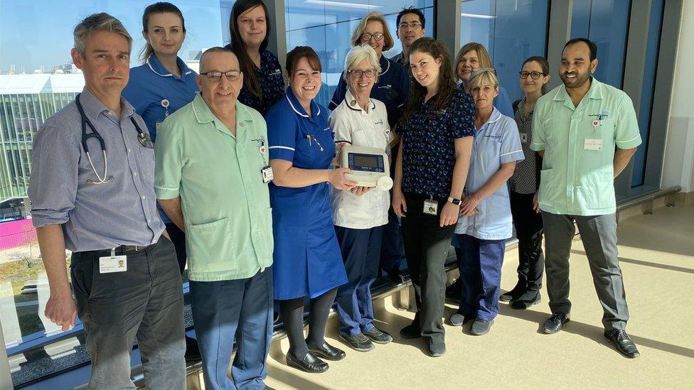 Staff at Royal Papworth Hospital in Cambridge with Professor Stephen Hawking's old ventilator, which has now been donated to the hospital to help care for patients with Covid-19