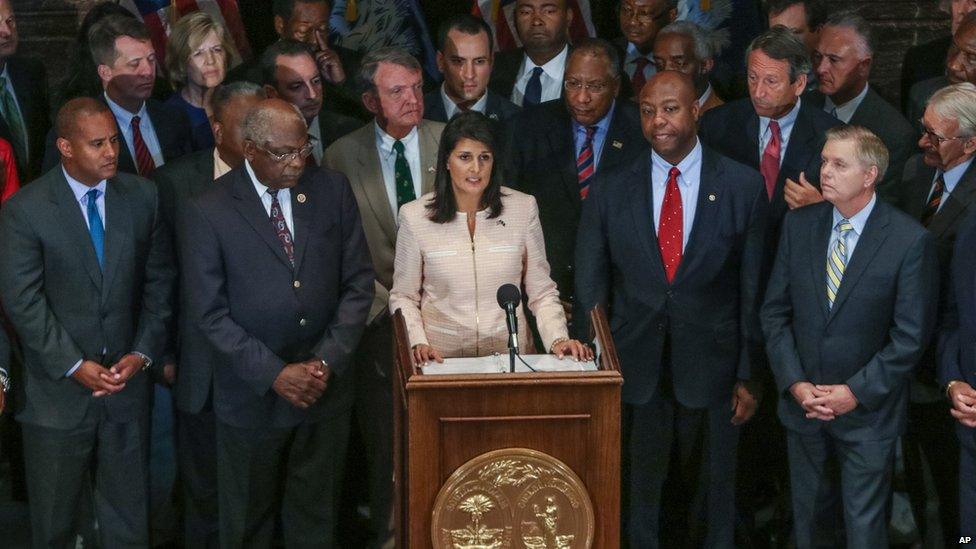 South Carolina Gov. Nikki Haley, center, calls for legislators to remove the Confederate flag from the Statehouse grounds during a news conference in the South Carolina State House in Columbia, S.C., Monday, June 22, 2015.