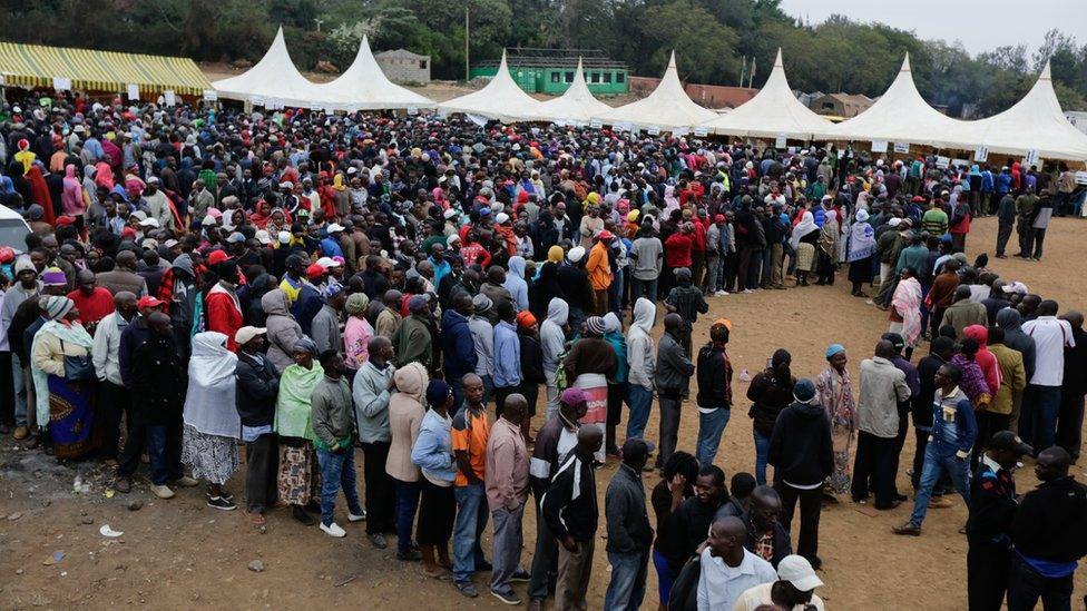 Voters queue as they wait to cast their votes at a polling station in the Kibera slum, Nairobi, Kenya