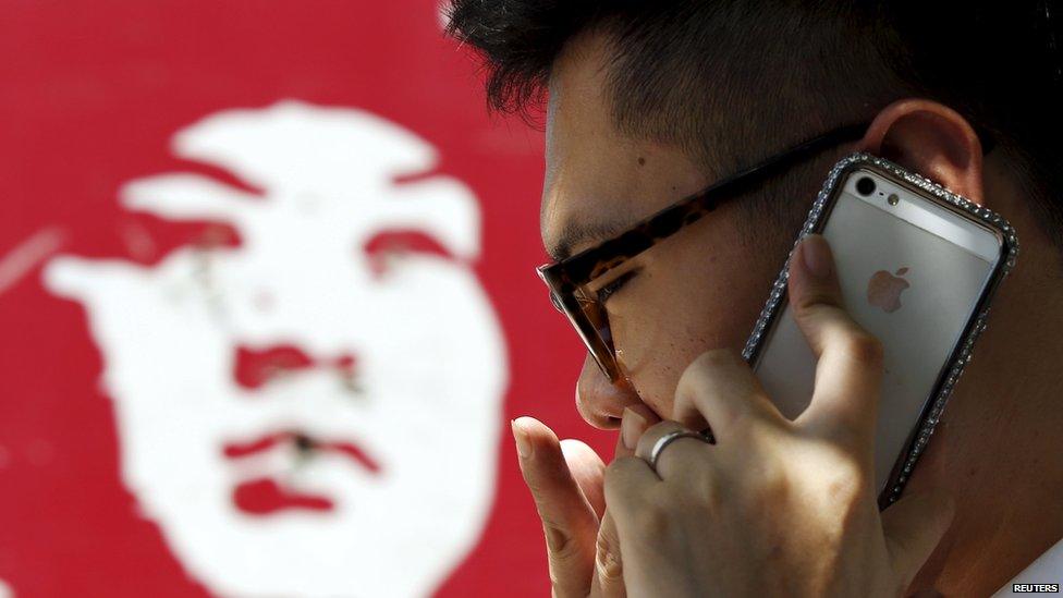 A man talks on an iPhone in Beijing, 24 July 2013