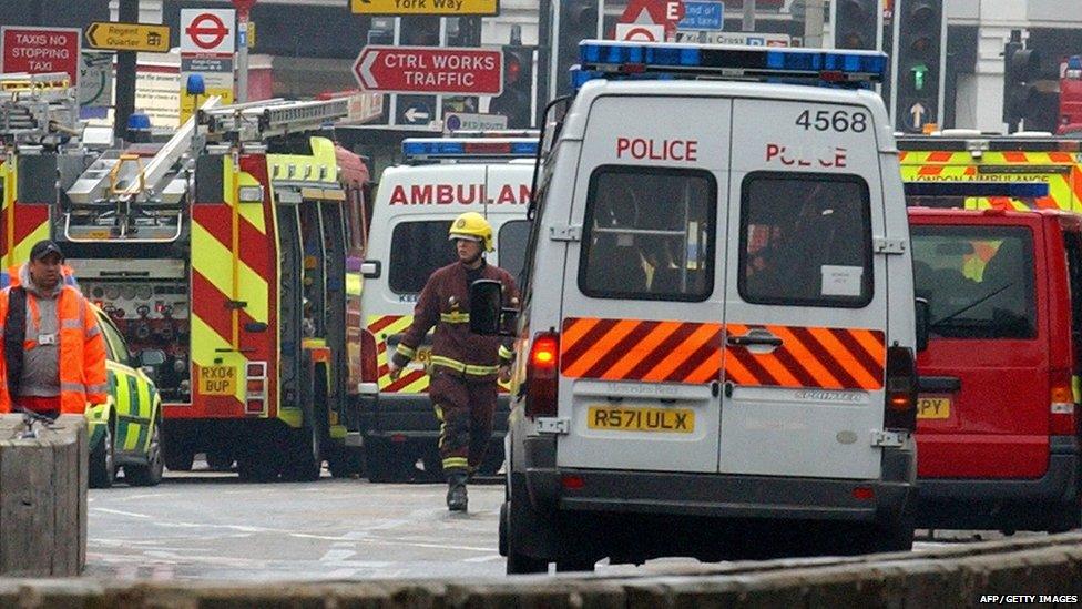 Ambulances and police vans stand at the ready in front of London's Kings Cross Station after a terrorist bomb exploded on the subway 07 July, 2005.