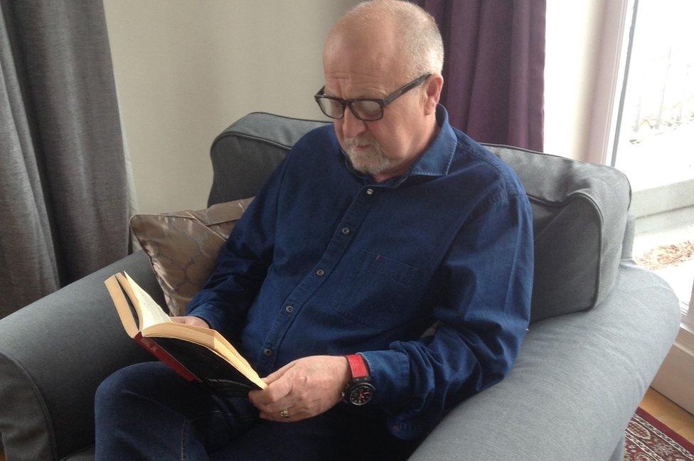 John Skinner reading a book