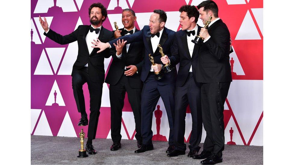 Team holding their Oscars