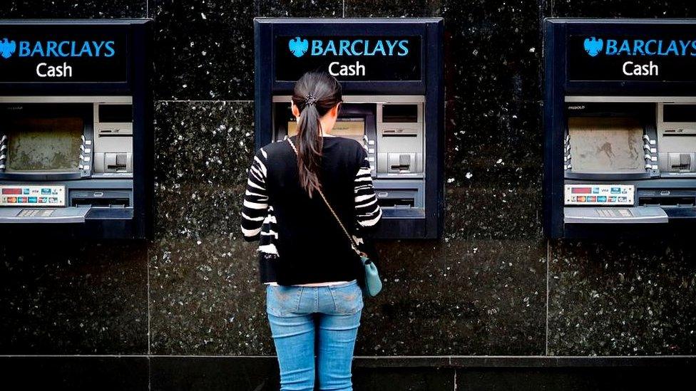 Woman at Barclays cash point