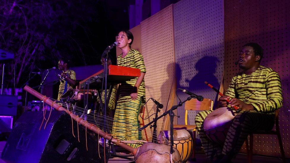 (Right to left) Maboudou Sanou, Keiko Fujiie, Boureima Sanou and Ibrahim Dembélé perform the first act of the opera Là-bas ou Ici (Here or There) at the Institut Français in Ouagadougou on April 23, 2021.