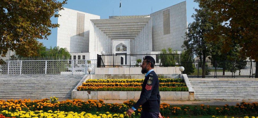 A policeman walks past in front of the Supreme Court building