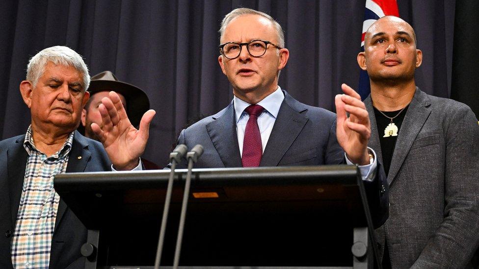 Anthony Albanese announces the proposed wording of the Voice, surrounded by Indigenous supporters