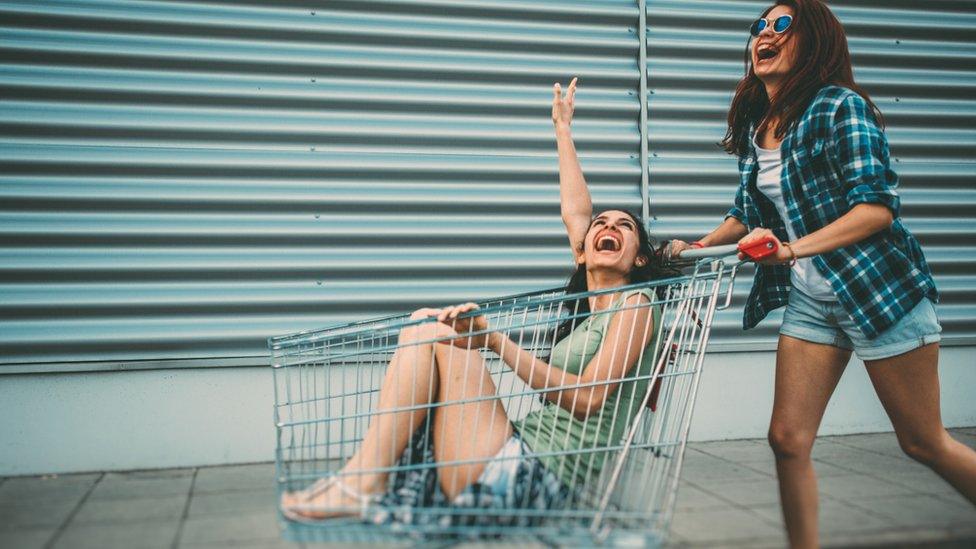 Two women with a shopping trolley