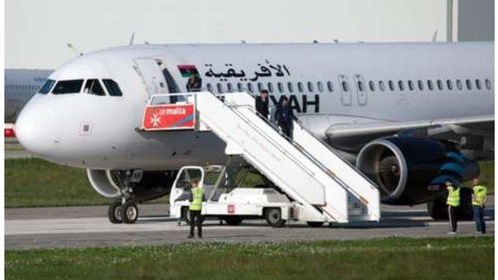 Hostages disembarking from plane in Malta