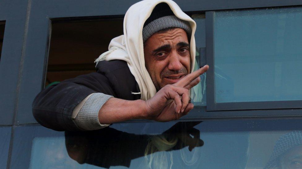 A Syrian man, who was evacuated from rebel-held neighbourhoods in the embattled city of Aleppo, gestures as he arrives in the opposition-controlled Khan al-Aassal region, west of the city