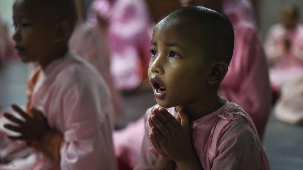 This photo taken on October 19, 2019 shows Buddhist nuns praying in the Mingalar Thaikti nunnery in Yangon.