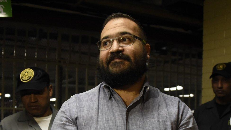 Javier Duarte, former governor of the Mexican state of Veracruz, is escorted by police officers for an extradition hearing in Guatemala City on July 4, 2017