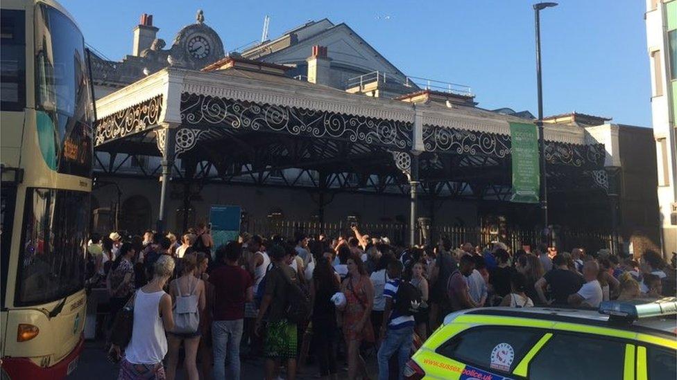 People outside a closed Brighton Station