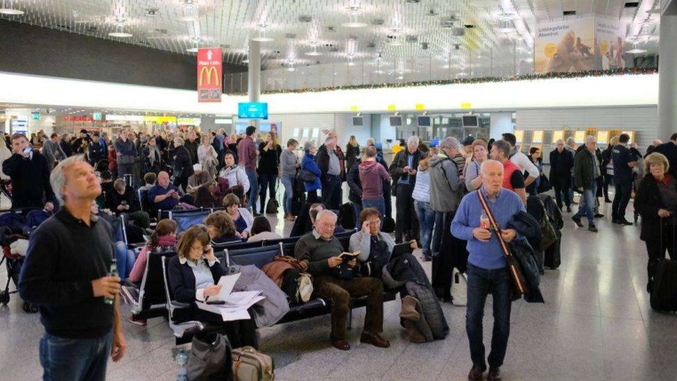 Passengers wait at the airport in Hanover, 29 December 2018