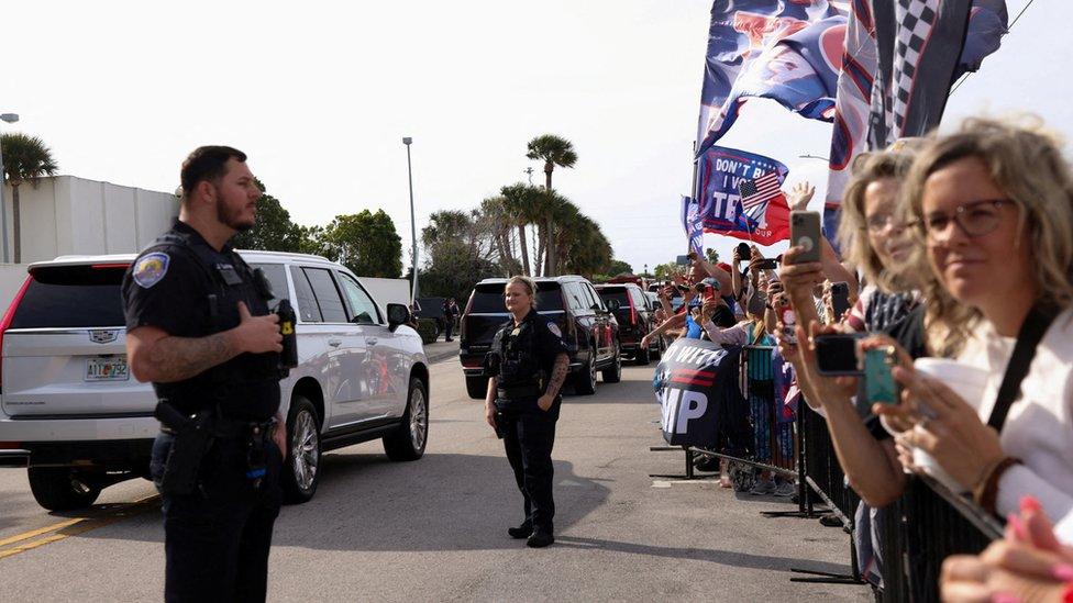 People gather as the motorcade of former U.S. President Donald Trump arrives to the U.S. District Court Magistrate in Fort Pierce, Florida, U.S., March 1, 2024