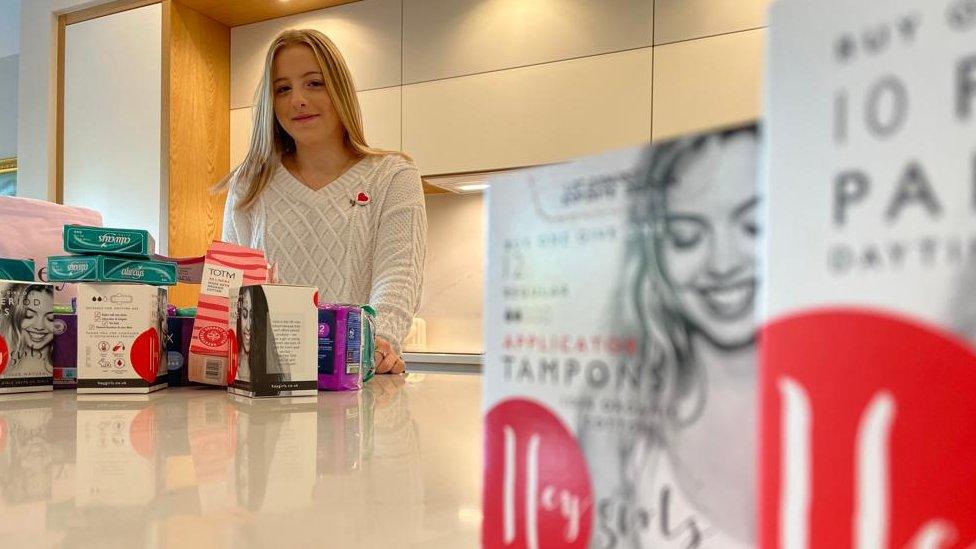 Tilly is in the background with a range of sanitary products next to her and in the foreground.