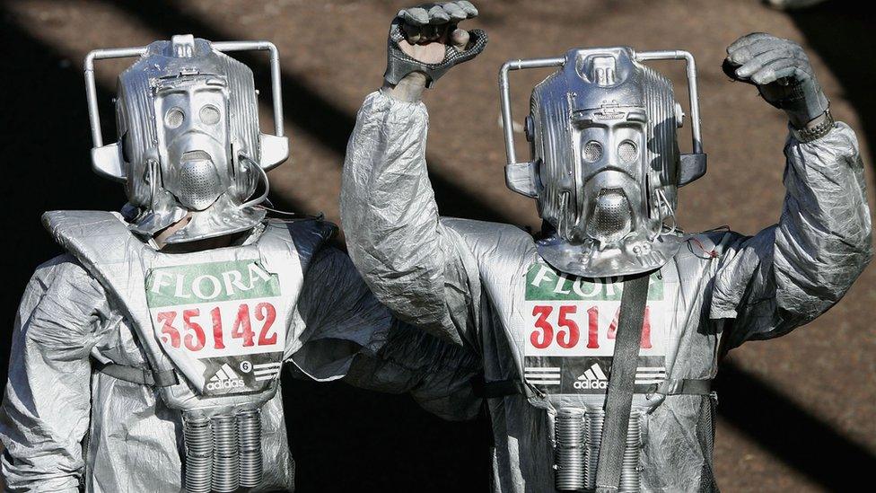 Fun runners dressed as Cybermen celebrate after crossing the finish line during the 2005 London Marathon