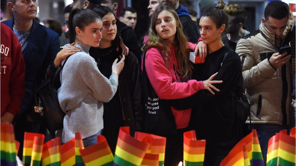 Australians gather to place candles and flags in Sydney on June 13, 2016, in solidarity with the global gay community after a gunman opened fire in a nightclub in Orlando, Florida, killing over 50 people