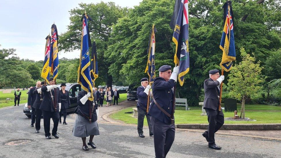 Flag bearers and funeral cortege