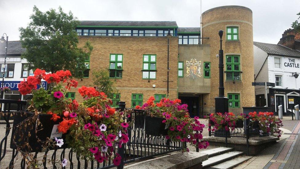 Luton Crown Court with flowers in front of it