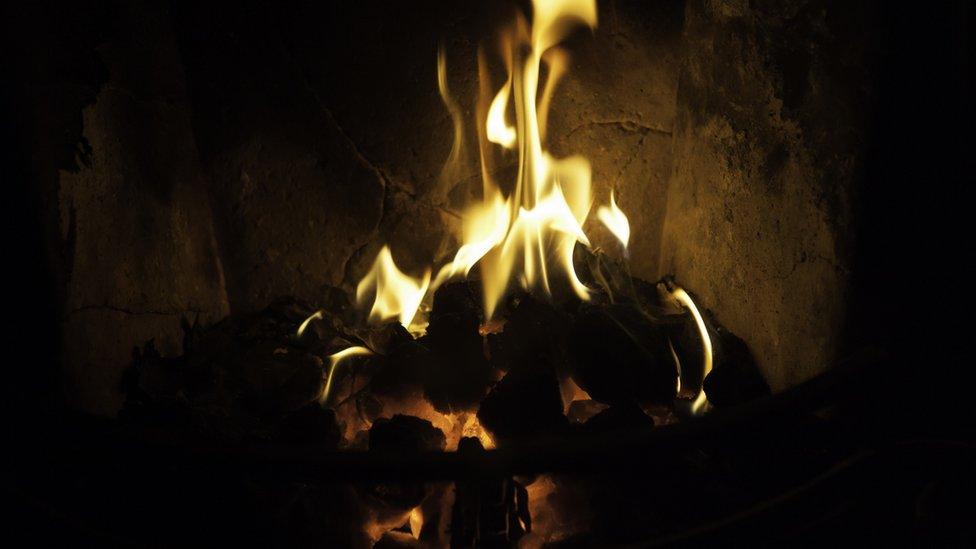 Coal burning on an open fire indoors