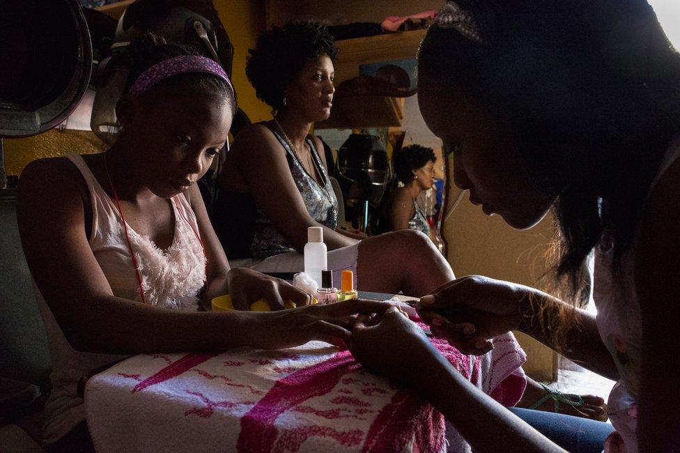 A young girl gets her nails tended to at one of the many salons