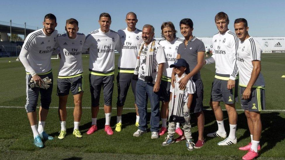 Osama Abdul Mohsen and his sons Mohammad and Zaid pose with Real Madrid players, goalkeeper Kiko Casilla, Russian midfielder Denis Cheryshev, Portuguese forward Cristiano Ronaldo, Portuguese defender Pepe, Croatian midfielder Luka Modric, German midfielder Toni Kroos and midfielder Lucas during a training session at Valdebebas training ground