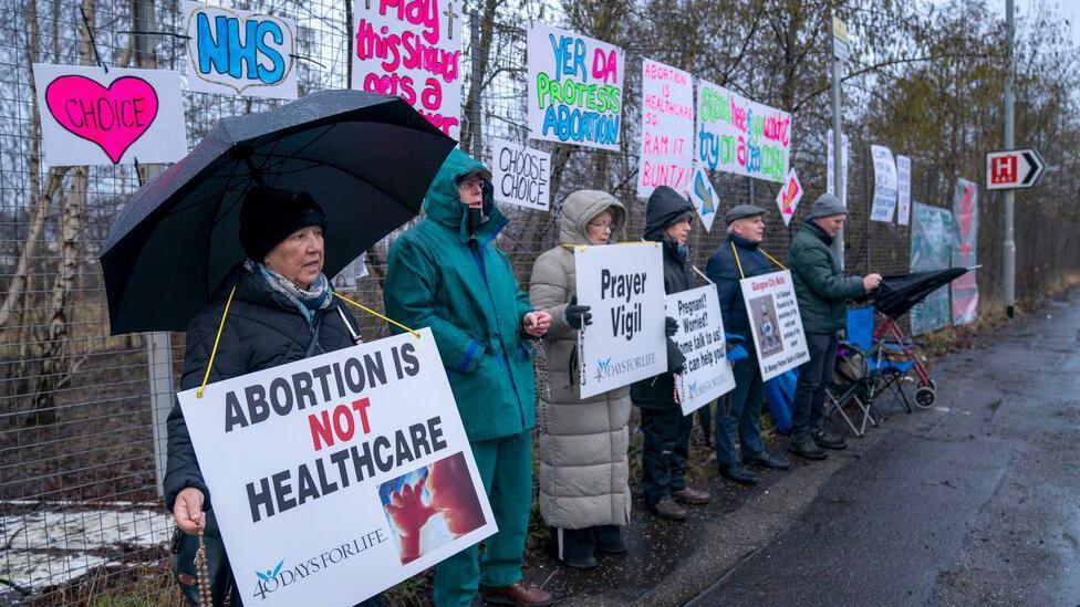 People take part in an anti-abortion protest, organised by 40 Days For Life, on Hardgate Road, close to the Queen Elizabeth University Hospital