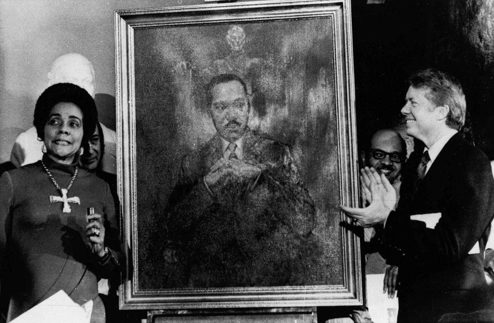 Coretta Scott King, widow of slain civil rights leader Dr. Martin Luther King, Jr., speaks at an unveiling of a portrait of Dr. King by artist George Mandus, Feb. 18, 1974, and dedicated by Gov. Jimmy Carter. It is the first portrait of an African American to be represented in the state's official portrait gallery.