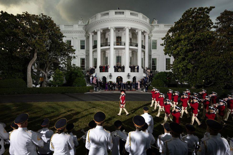 US President Joe Biden and First Lady Jill Biden watch the Old Guard Fife and Drum Corps march on the South Lawn of the White House