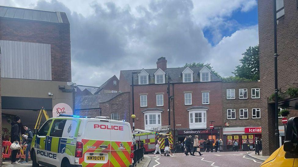 Emergency services in a city centre with some smoke