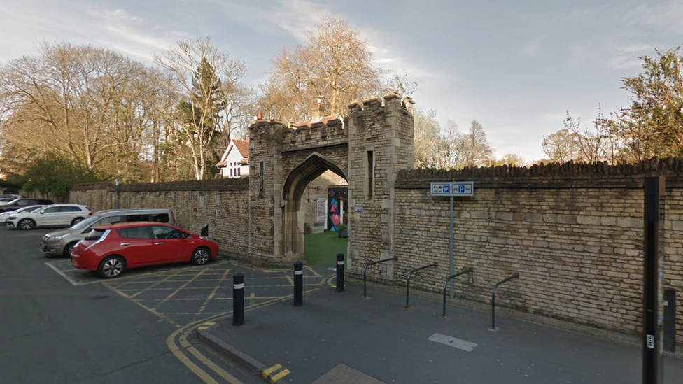 Chauffeurs Cottage visible through the a cathedral gateway on St Peter's Road in Peterborough