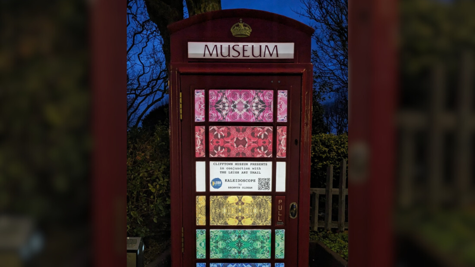 The telephone box lit up at night