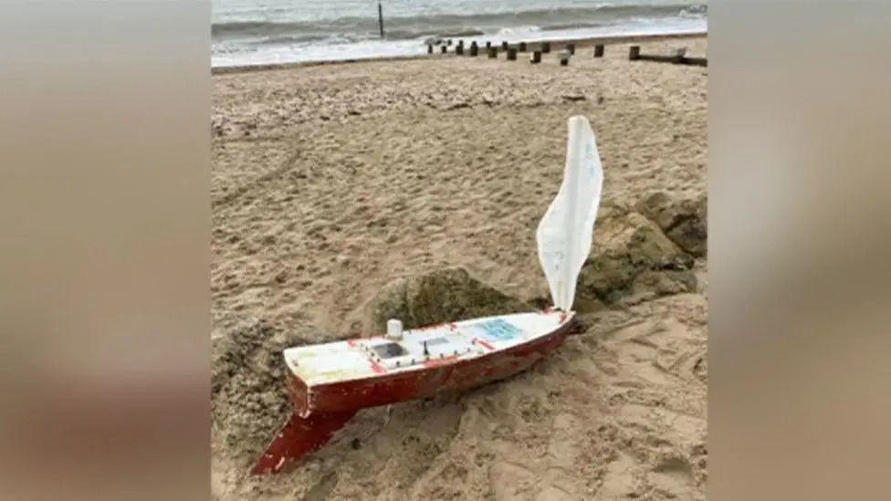 The battered mini boat washed up on Avon Beach