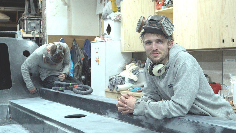 Ewan and Lachlan MacLean sanding the deck